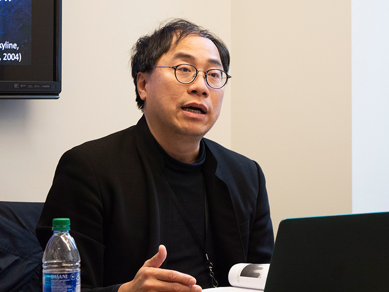 A photo of Perry Yang presenting at a conference.