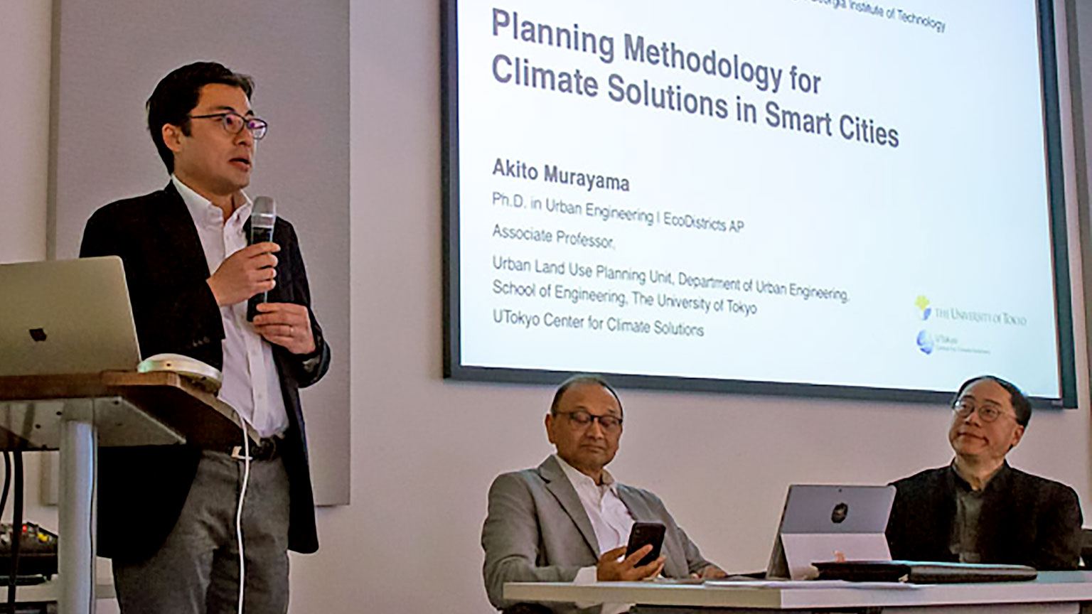 Smart Cities Systems Design panelist presents research.
