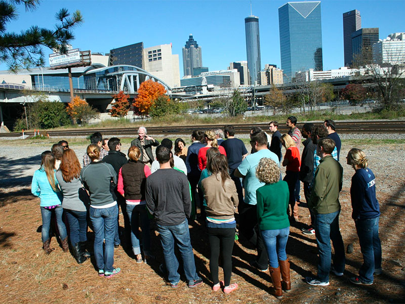 Mike Dobbins leads a student tour of Atlanta, near the stadium.