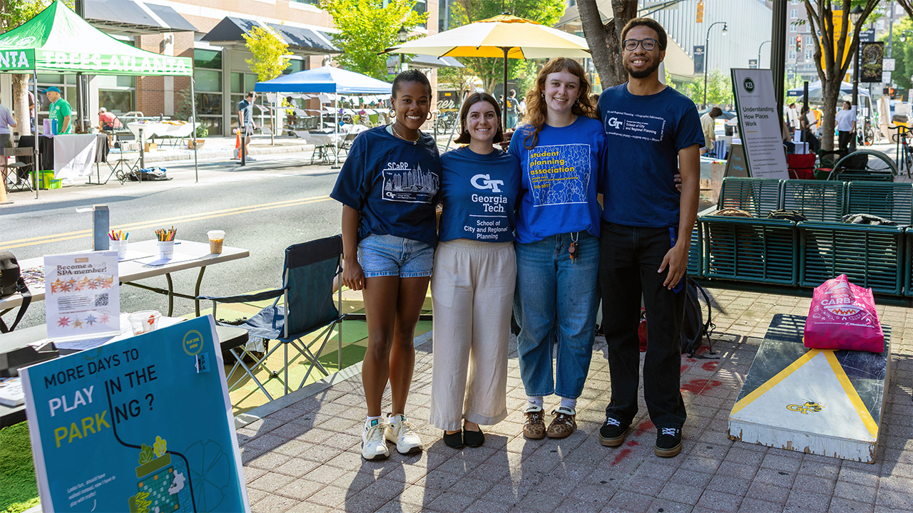 students pose for parking day
