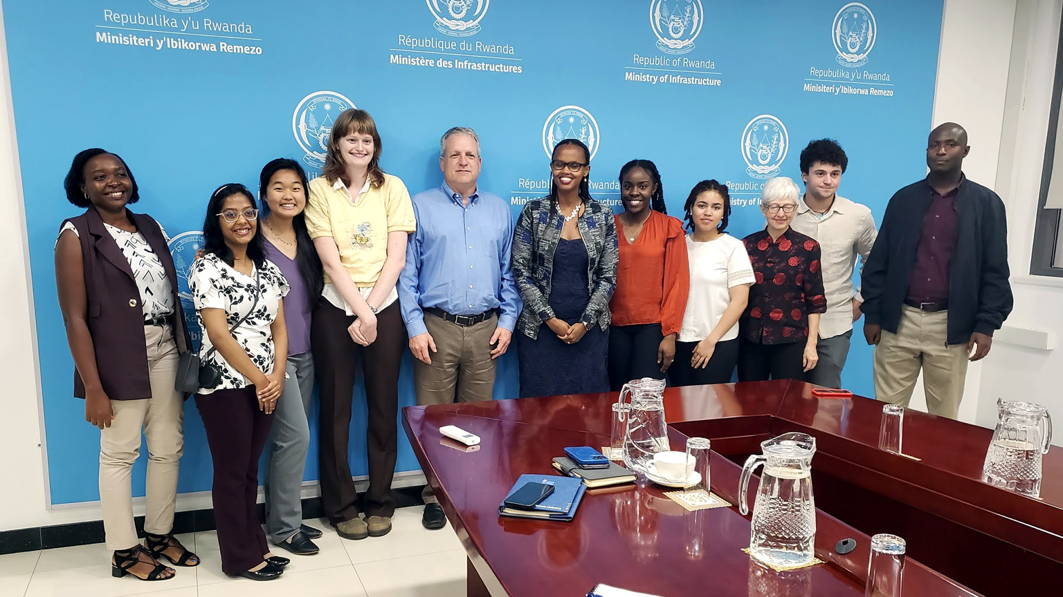 Group photo of Georgia Tech students and faculty with Patricie Uwase, in a conference room